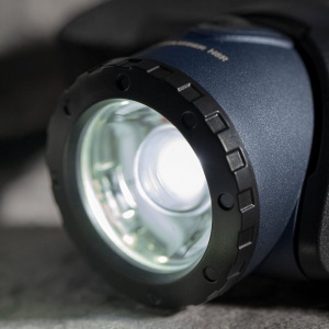 Vedere frontală a lanternei Ledlenser H8R Ediție 25 Ani cu banda de cap neagră și logo-ul aniversar vizibil