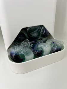 Dispenser tide pods deschis cu capsule detergent în interior