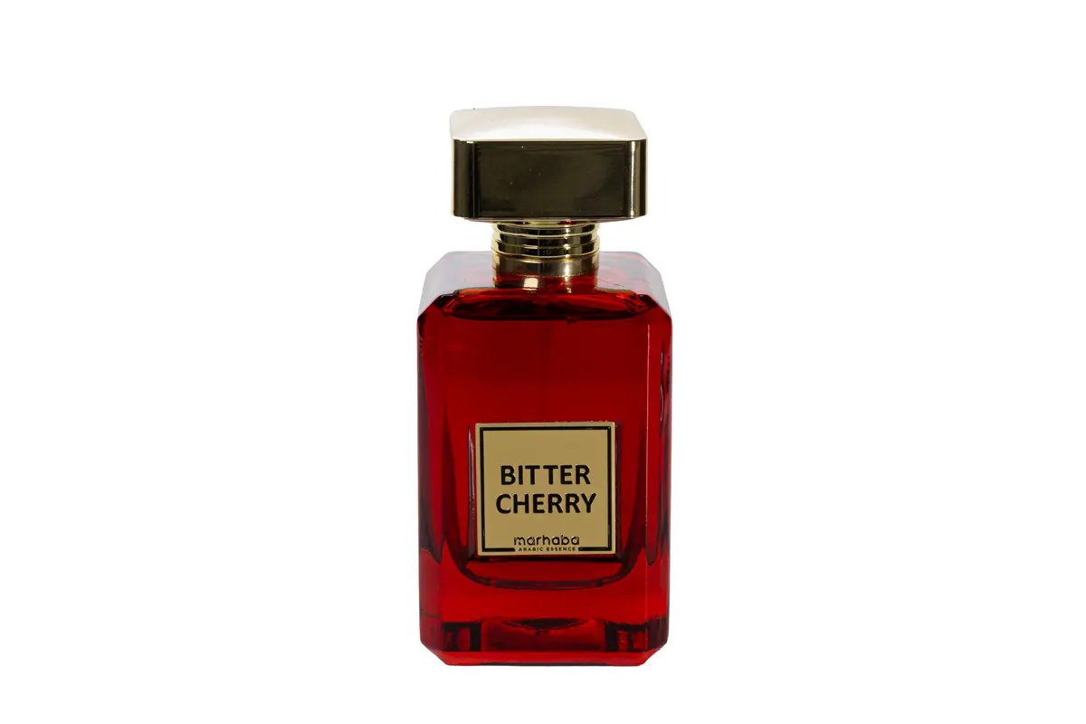 Flacon Bitter Cherry Marhaba Eau de Parfum 100 ml pe fundal alb cu sticlă roșie și capac auriu