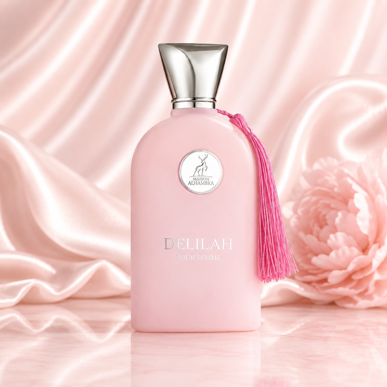 Sticlă parfum Delilah Maison Alhambra 100 ml roz pudrat cu ciucure decorativ pe fundal satinat